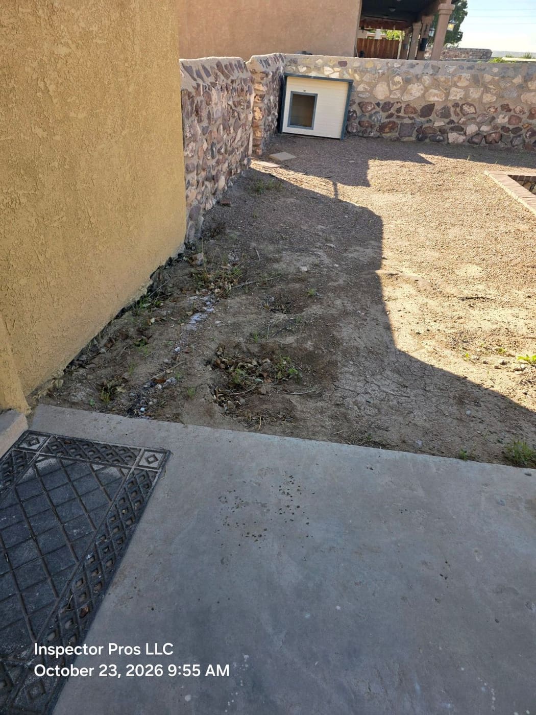 Bare soil along a side yard with no slope away from the foundation