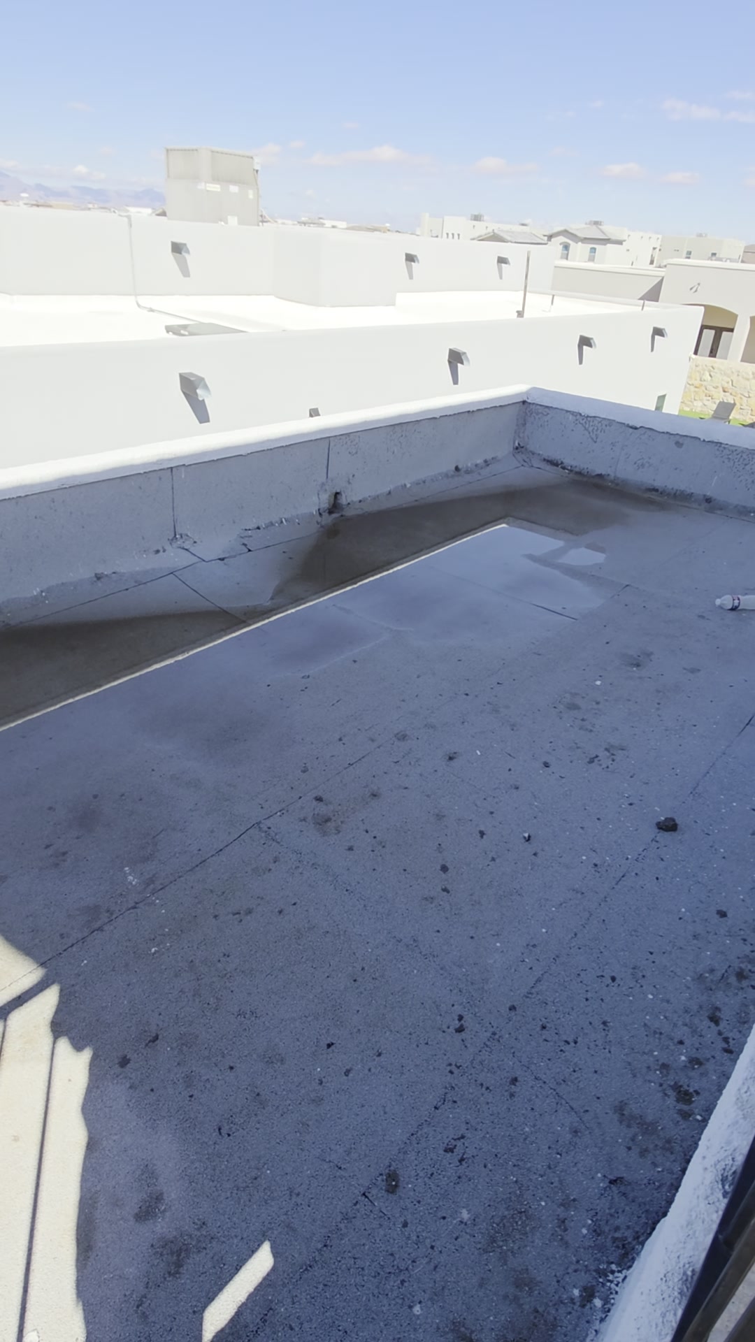 Flat roof with parapet walls and scupper drains on an El Paso home