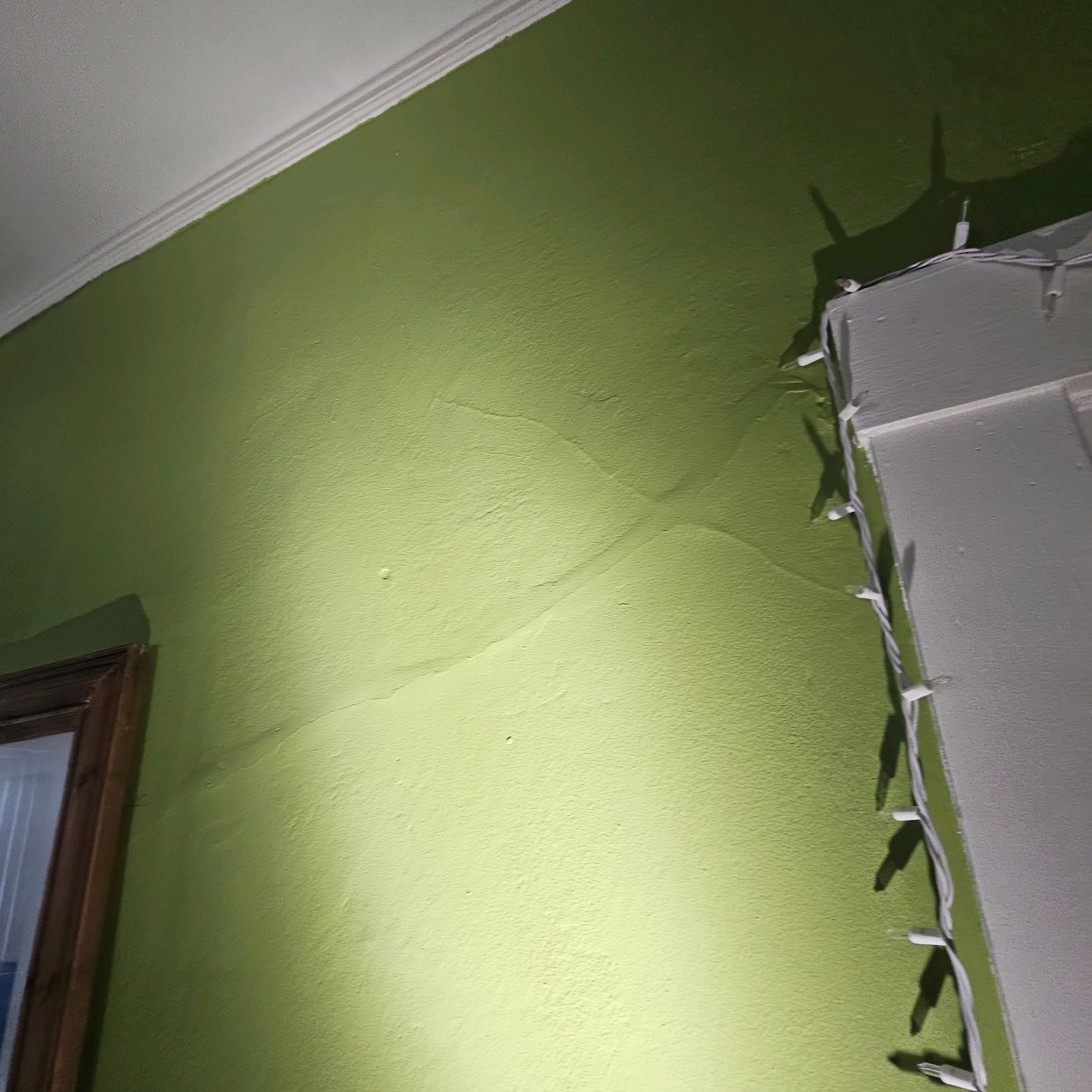 Diagonal drywall crack at the corner of an interior door opening in an El Paso home