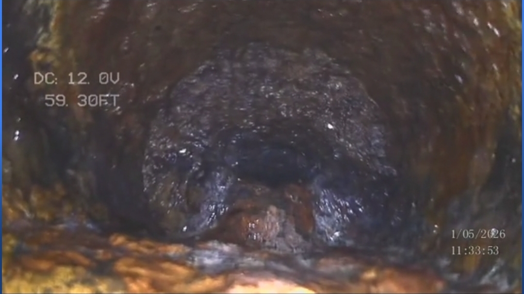 Corroded pipe interior visible on sewer scope camera showing wall deterioration
