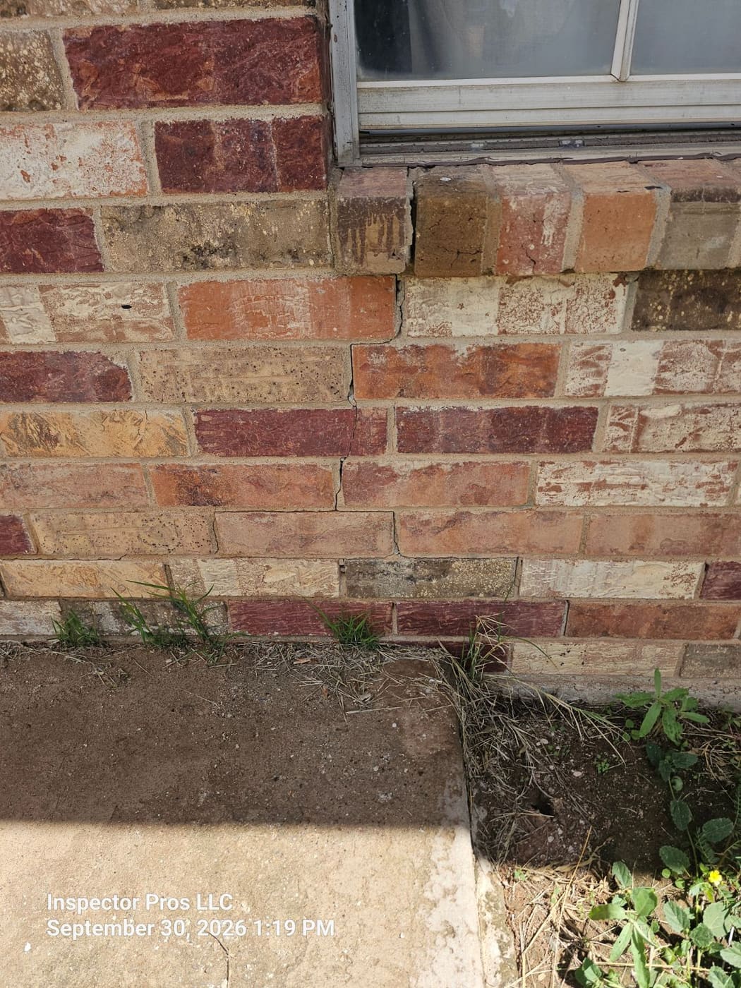 Crack in brick veneer below a window on an El Paso home