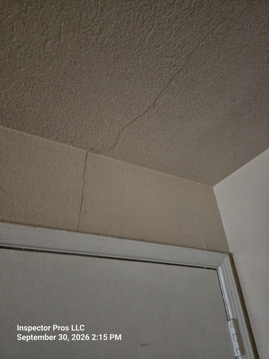 Drywall crack running from a door corner up to the ceiling inside an El Paso home